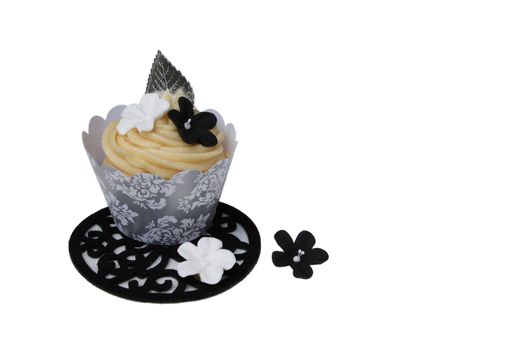 Vanilla cupcake in silver cup with flowers