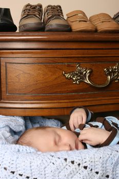 Month old baby boy sleeping in a drawer 