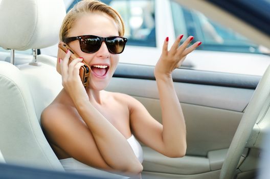 Lady on the phone with lots of emotions while driving
