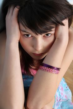 Beautiful brunette teen with a serious facial expression