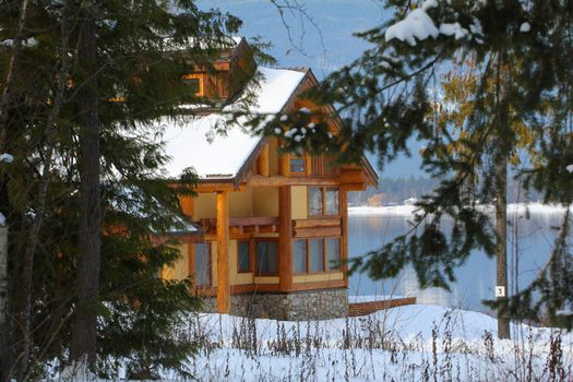 Log Cabin on the shore with snow