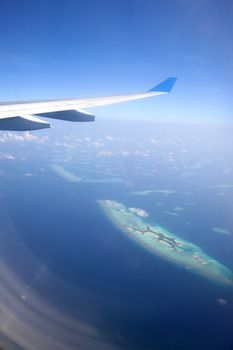 Aerial view of the Maldives and airplane - Paradise in the middle of the Indian ocean