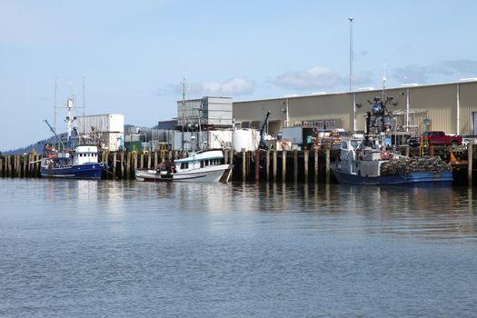 Fishing boats unloading their cargo at the Astoria port, OR.