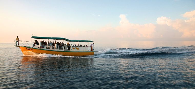 Ship in the Maldives cruising between the reef