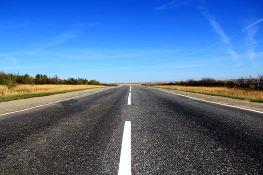 Summer landscape with line of road and blue sky