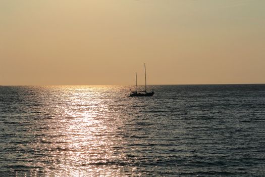 Landscape with calm sea and beautiful sailboat