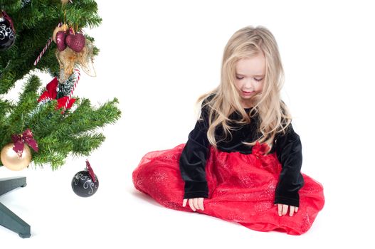 Beautiful baby girl dressed up for Christmas isolated in white