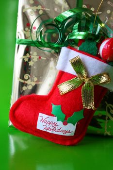 Christmas stocking against a gold wrapped present
