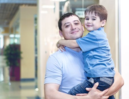 Mum and the son discuss purchases in shopping center