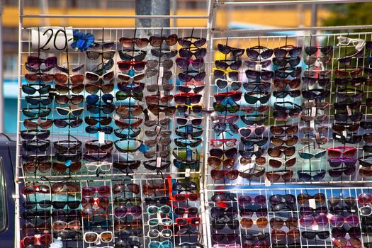 Colorful sun glasses selling on a stand
