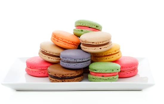 Delicious French macaroons in assorted colours on a serving dish.