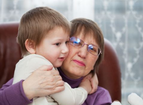 Little boy with his grandmother embracing each other