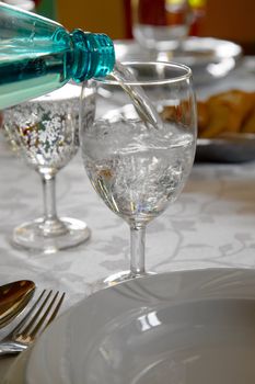 Pouring water into a glass in a restaurant