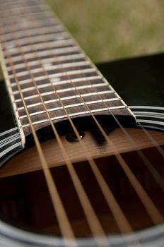 Black acoustic guitar with steel strings