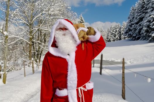 Santa Claus, Father Christmas in a beautiful winter landscape