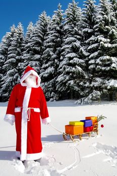 Santa Claus, Father Christmas with colorful presents on a sledge