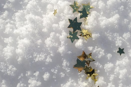 golden snow stars on a real snowy icy surface