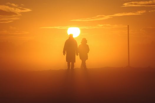 a couple have a walk through a misty landscape