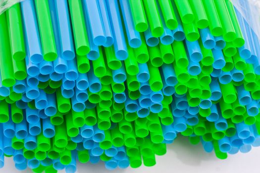 Very close shot of plastice straws plied upon each other.