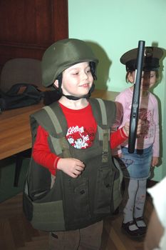 WROCLAW, POLAND - April 3: Open Day of National Bank of Poland. Small boy tries security guard vest and helmet on April 3, 2011.