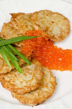 pancakes with red caviar and green onion closeup dish