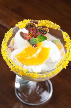 Ice cream dessert with kiwi and orange decorated with butterfly
