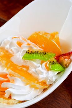 Ice cream dessert with kiwi, strawberry and orange