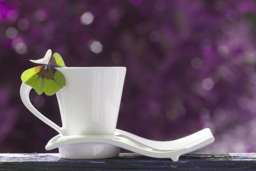 cup of tea with four-leaf clover