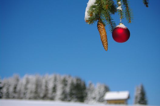 red bauble christmas ball ornament outside in a snowy winter scene