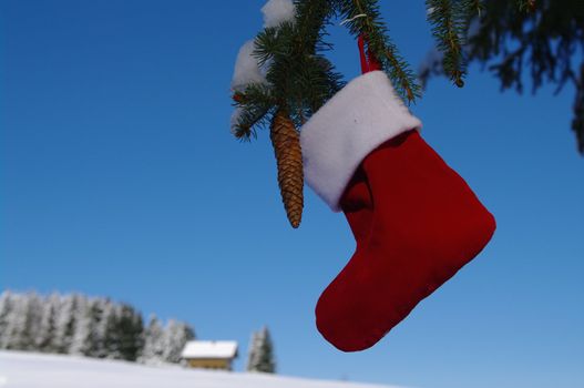 Santa Claus Christmas boot for gifts outside in a snowy landscape