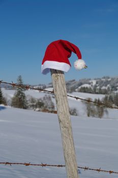 red santa claus hats in a snowy landscape