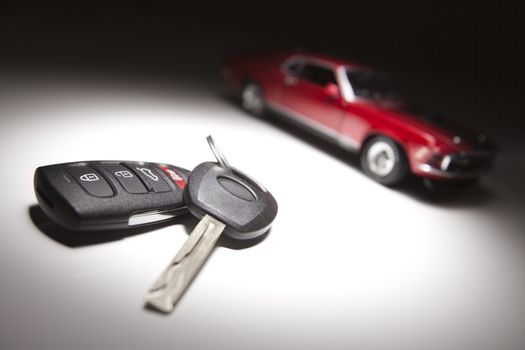 Car Keys and Sports Car Under Spot Light.