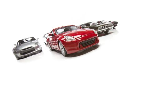 Several Sports Cars Racing Isolated on a White Background.