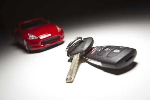 Car Keys and Sports Car Under Spot Light.