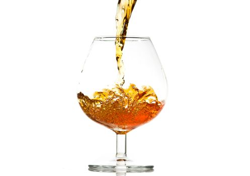 filling a glass of brandy, close-up