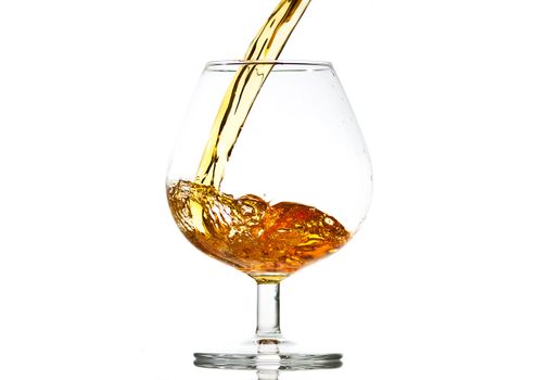 filling a glass of brandy, close-up