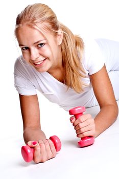 pink dumbbells in the hands of women on a white background