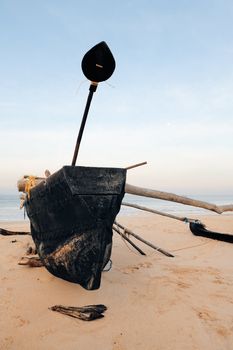 Old fishing boat on the sandy beach in Goa