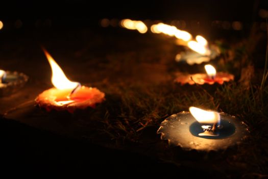 Traditional candles lit in a garden on teh occassion of Diwali festival in India.