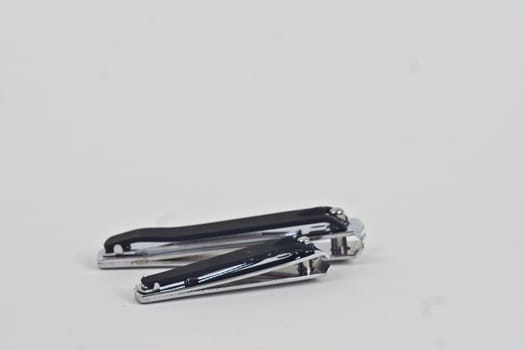 A pair of large and small finger and toe nail clippers on a white background