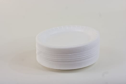 white styrofoam plates on a white background.
