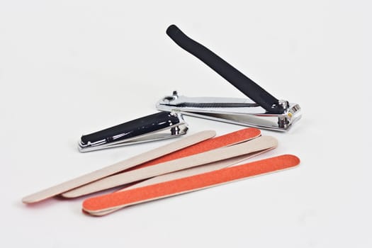 Large and small finger nail clippers with emory boards on a white background.
