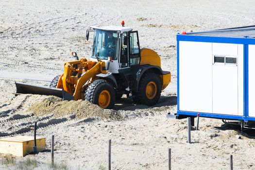 Work at the beach - equalizing sand for placing cabins to prepare for the summer season