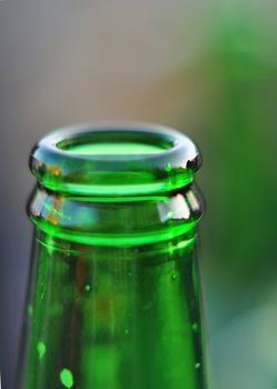 Neck of the beer bottle close detail in natural backgound