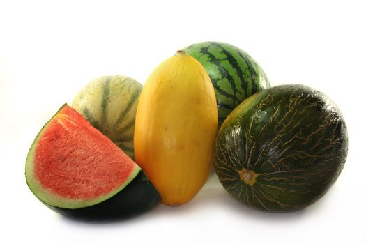 different varieties of melon on a white background