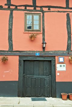 Pink Wall Spanish House with Wooden Beams and Door