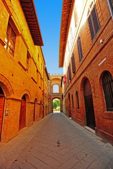 Narrow Alley With Old Buildings In Italian City of Siena