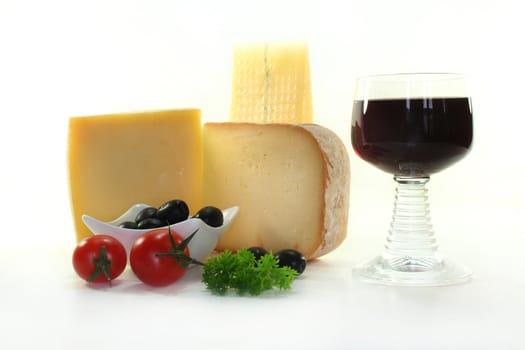 different varieties of cheese with fresh tomatoes and olives