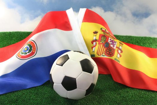 Country Flags and a football against a cloudy sky