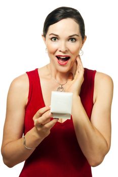 Surprised beautiful young woman holding an open jewellery gift box and looking at camera.